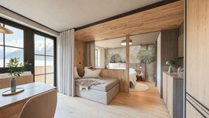 A modern bedroom with a large window, a cozy bed, a desk, and a view of mountains. - Apartment fur bis zu 4 Personen (Kaprun)
