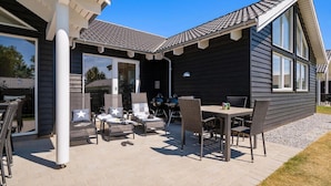 A covered patio with outdoor furniture and a grill area. - VillaVilla 716 - Olpenitz, Deutschland (Kappeln)