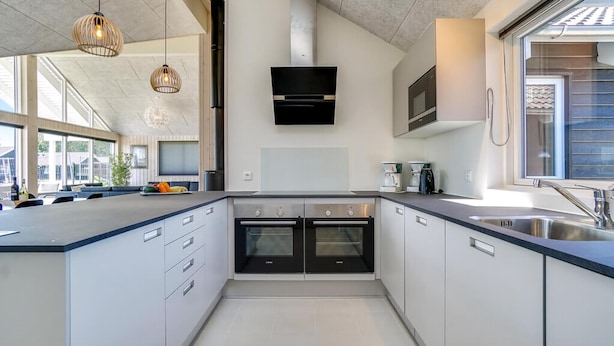 A modern kitchen with built-in ovens, a microwave, and a coffee maker. - VillaVilla 716 - Olpenitz, Deutschland (Kappeln)