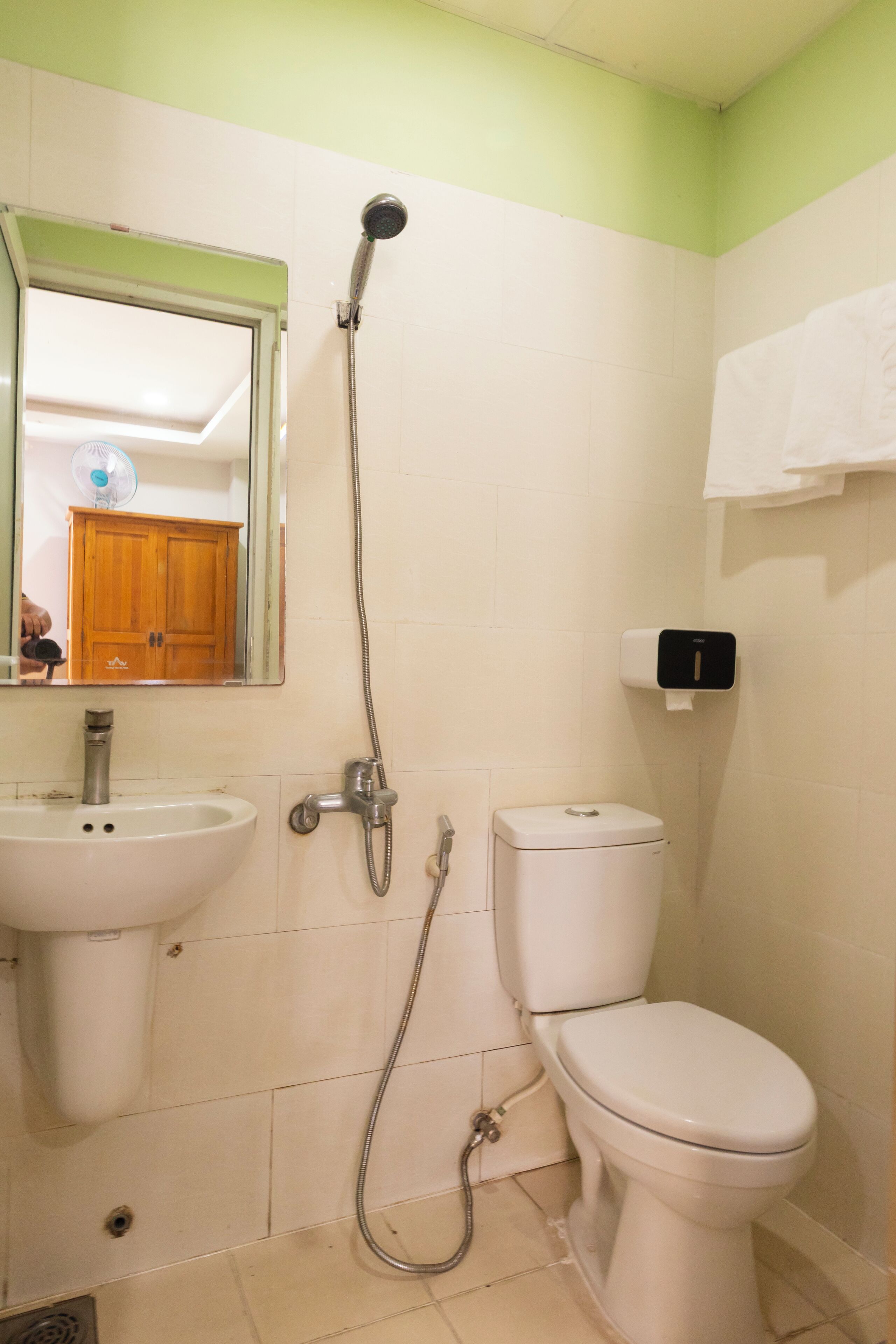 A bathroom with a sink, toilet, and shower.