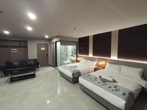 A modern hotel room with two beds, a sofa, a glass-enclosed shower, and a minibar. - Skyport Hotel (Parañaque)