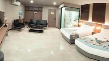 A hotel room with a bed, a sofa, a desk, and a mirror.