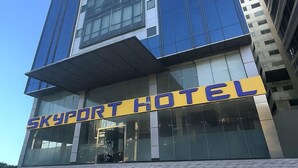 A modern hotel with a prominent 'SKYPORTHOTEL' sign, large glass windows, and a clean, contemporary design. - Skyport Hotel (Parañaque)