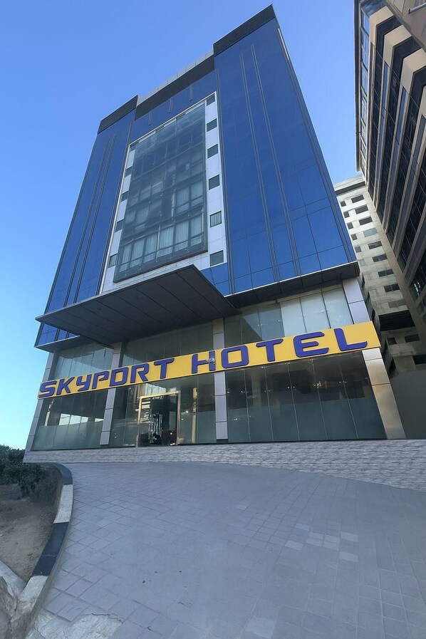 A modern hotel with a prominent 'SKYPORTHOTEL' sign, large glass windows, and a clean, contemporary design. - Skyport Hotel (Parañaque)