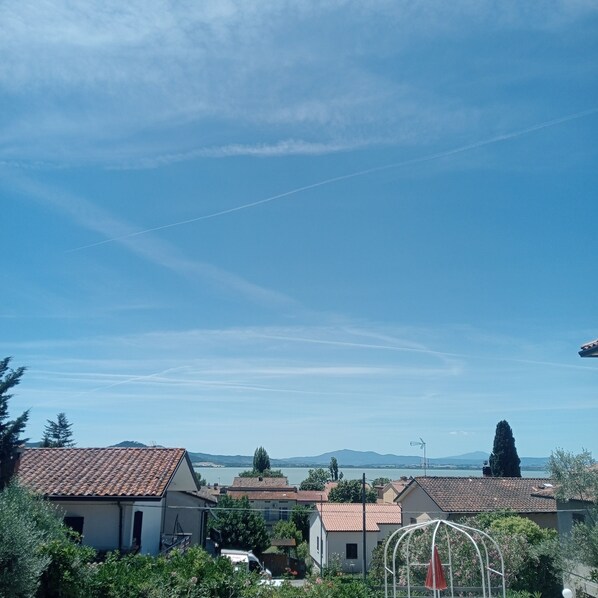 A residential area with houses, a clear sky, and distant mountains.