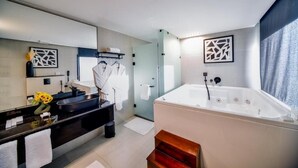 A modern bathroom with a large bathtub, a vanity with a sink, and a mirror. - venecia resort fayoum (Yusuf as-Sidiq)