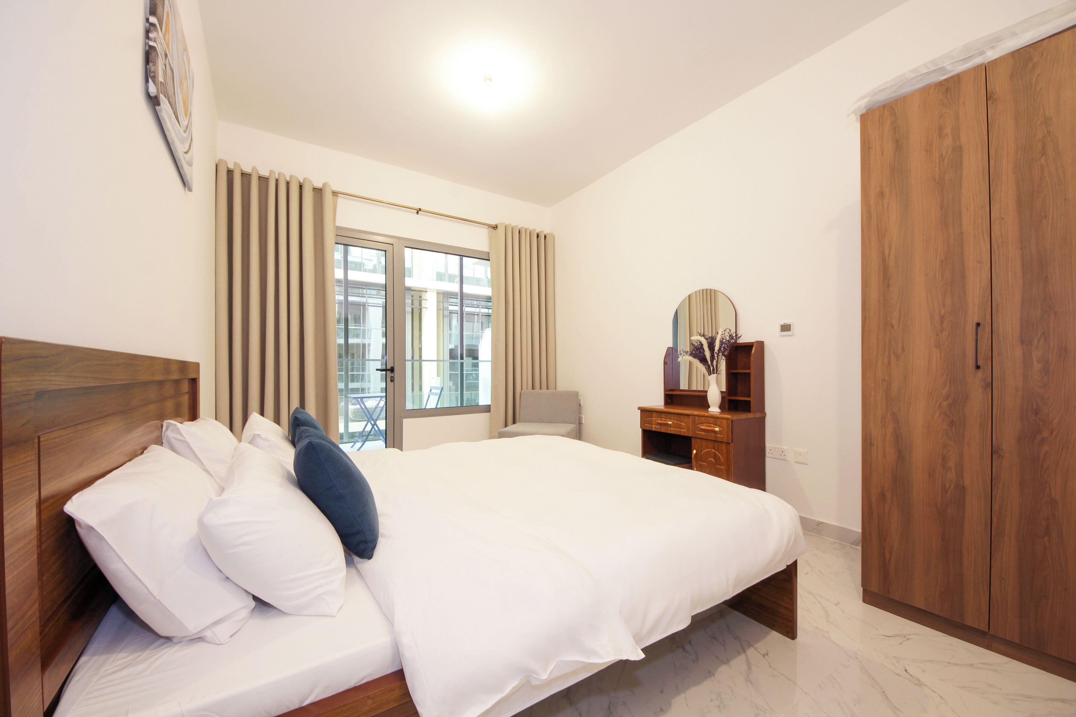 A bedroom with a wooden bed, a dresser, a mirror, and a wardrobe.