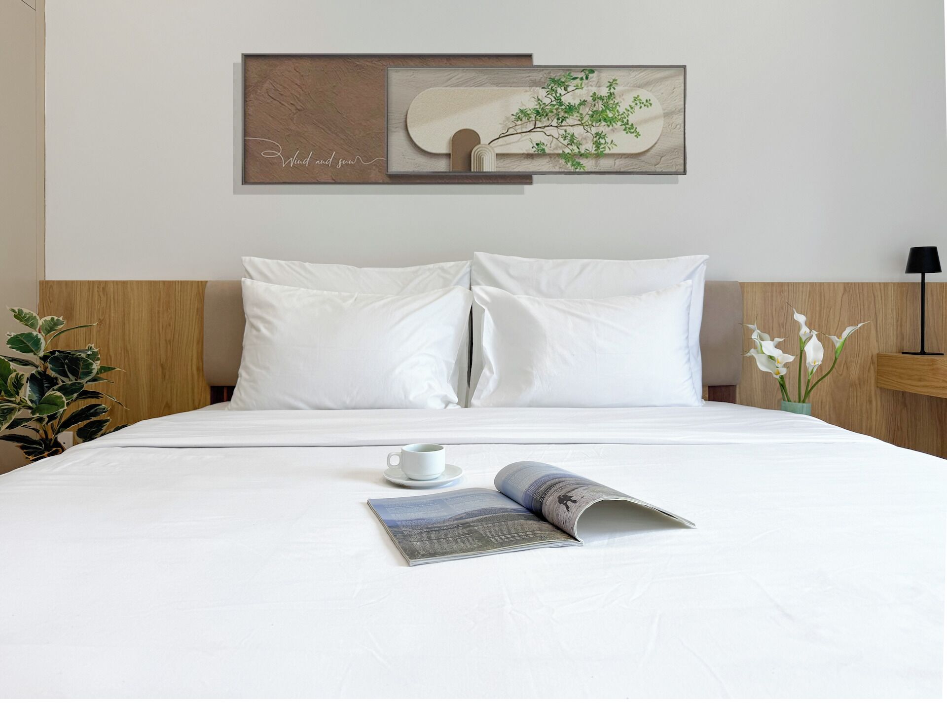 Una cama bien tendida con sábanas blancas, una taza de café y una revista sobre la cama.
