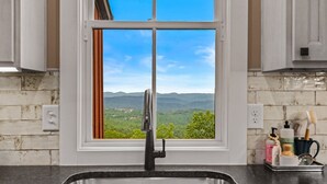 A kitchen with a window view of a mountainous landscape. - Western Ridge Lookout at Blue Ridge Mountain Club - community amenities with seasonal pool (Boone)