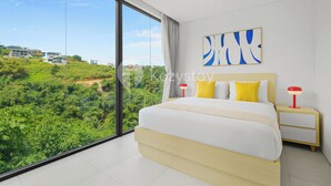A modern bedroom with a large bed, a nightstand, and a wall-mounted lamp.