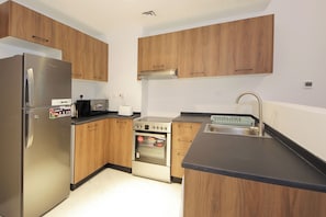 Apartment, Pool View | Private kitchen | Full-size fridge, microwave, oven, stovetop