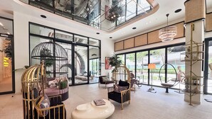 A spacious lobby with modern seating, large windows, and a high ceiling. - PVH - 2BR Golfville Dubai Hills (Dubai)
