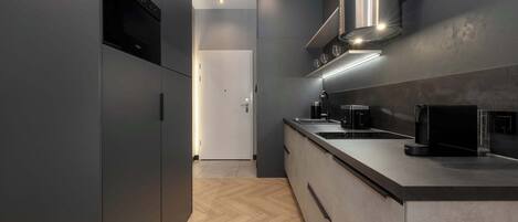 Fridge, stovetop, dishwasher, coffee/tea maker