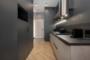 Fridge, stovetop, dishwasher, coffee/tea maker