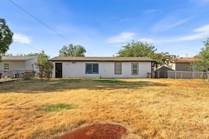A single-story mobile home with a front yard and a fenced backyard. - Cut the claustrophobia in hotels, enjoy freedom and quality space. (Abilene)