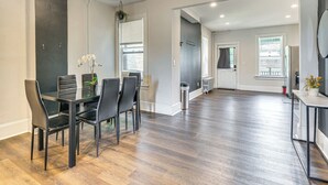 A modern kitchen with a dining area, featuring a wooden floor, black chairs, and a small potted plant. - 9 Mi to Shawnee Mtn! Stroudsburg Unit Near Main St (Stroudsburg)
