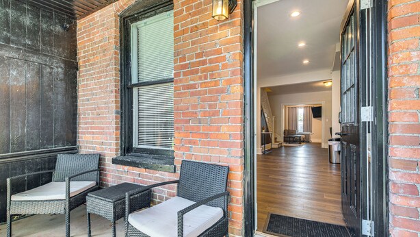 A brick exterior with a wooden door and a set of wicker chairs with cushions. - 9 Mi to Shawnee Mtn! Stroudsburg Unit Near Main St (Stroudsburg)
