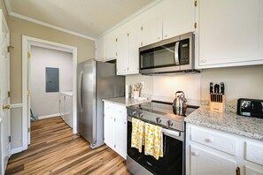 A kitchen with stainless steel appliances, a microwave, and a kettle. - 6 Mi to Med District: Greenville Home w/ Yard (Winterville)