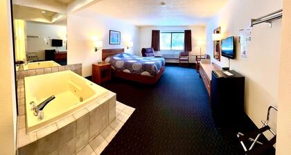 One queen bed, private bathroom, two-person whirlpool tub, mini fridge, and single-serve coffee maker.
