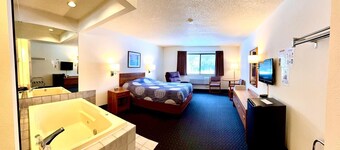 One queen bed, private bathroom, two-person whirlpool tub, mini fridge, and single-serve coffee maker.