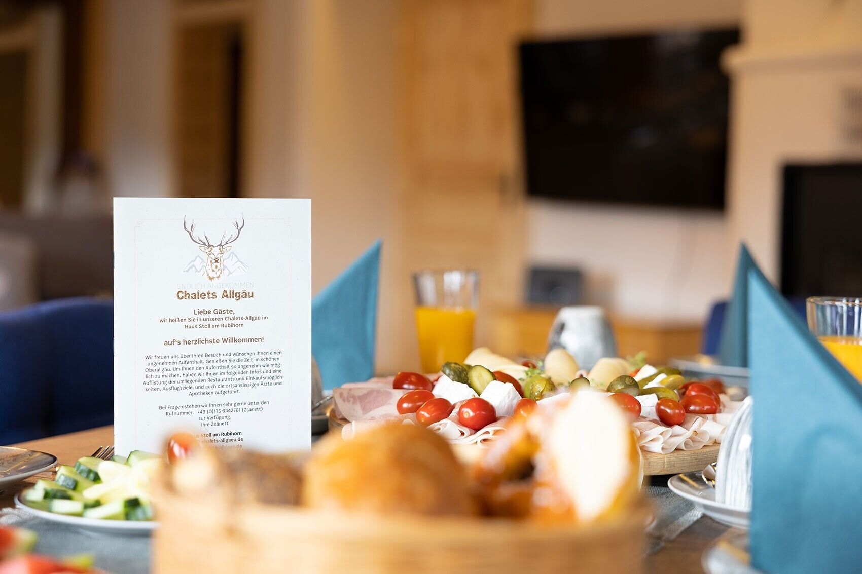 A restaurant setting with a menu, a variety of cheeses, tomatoes, and bread on the table.