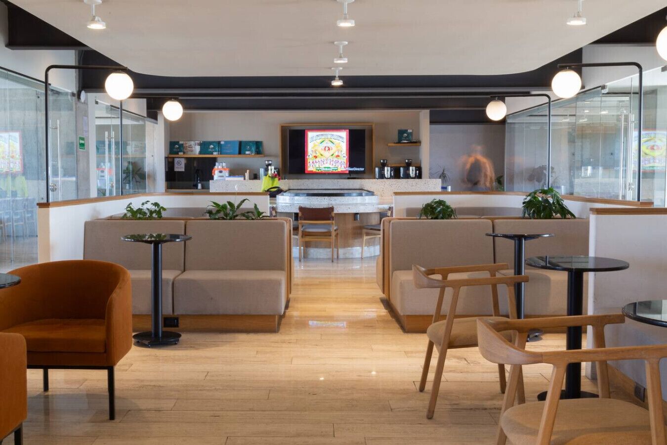 A modern interior with seating areas, a kitchen, and a bar.