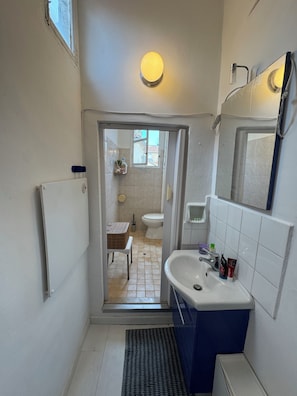 Shower, hair dryer, towels, toilet paper