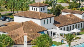 A residential area with multiple houses featuring tiled roofs and white walls.
