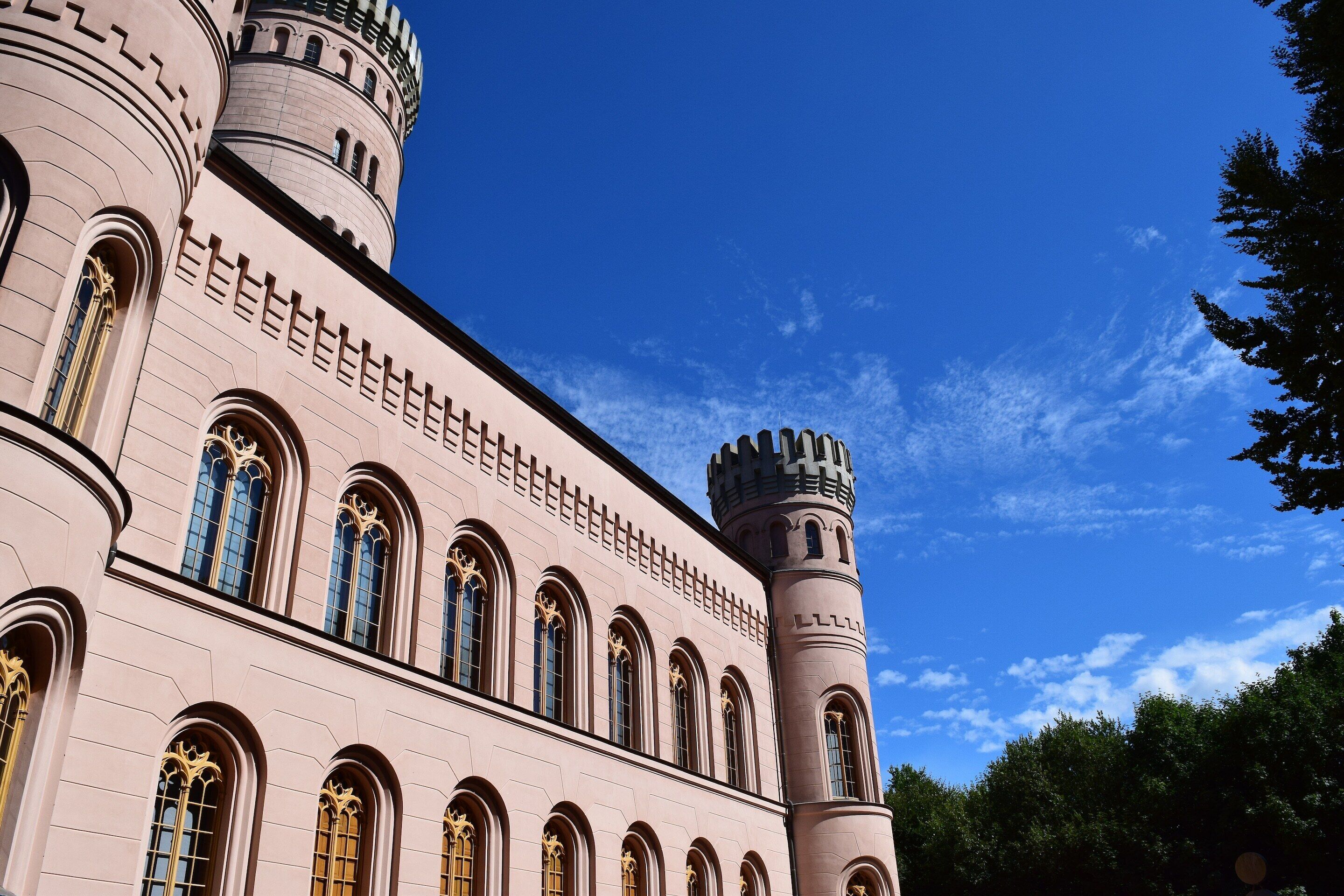 A large building with arched windows and two towers.
