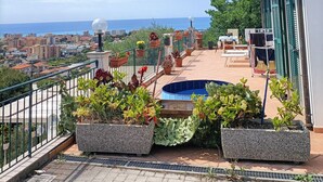 A rooftop terrace with a pool, potted plants, and a view of the city and sea. - "Casa Roque" Detached House with Ocean View + Parking Included (Vallecrosia)