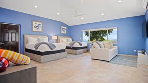 A modern bedroom with two beds, a sofa, and a TV. - Villa Francisca East-Spacious 3Bedroom Retreat with A/C – Your Perfect Getaway (St Thomas)