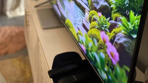 A television displaying a nature scene with flowers and rocks. - Casa Verde – Your Serene Escape in the Heart of Karen (Nairobi)