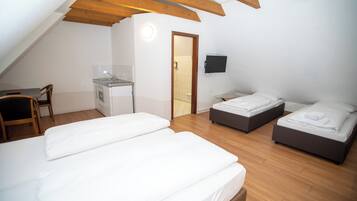 Family Quadruple Room, Courtyard View | Desk, laptop workspace, soundproofing, iron/ironing board