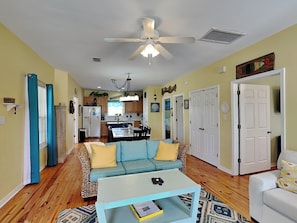 A living room with a sofa, coffee table, and a ceiling fan. - Coastal Cottage at The Rookery 3503 by Southern Vacation Rentals (Gulf Shores)