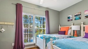 A bedroom with a large window, a bed with a blue and white bedspread, and a wall with a 'NO PROBLEM' sign. - Coastal Cottage at The Rookery 3503 by Southern Vacation Rentals (Gulf Shores)