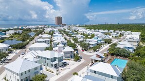 A coastal residential area with houses featuring gabled roofs and a central road. - Endless Summer by Southern Vacation Rentals (Orange Beach)