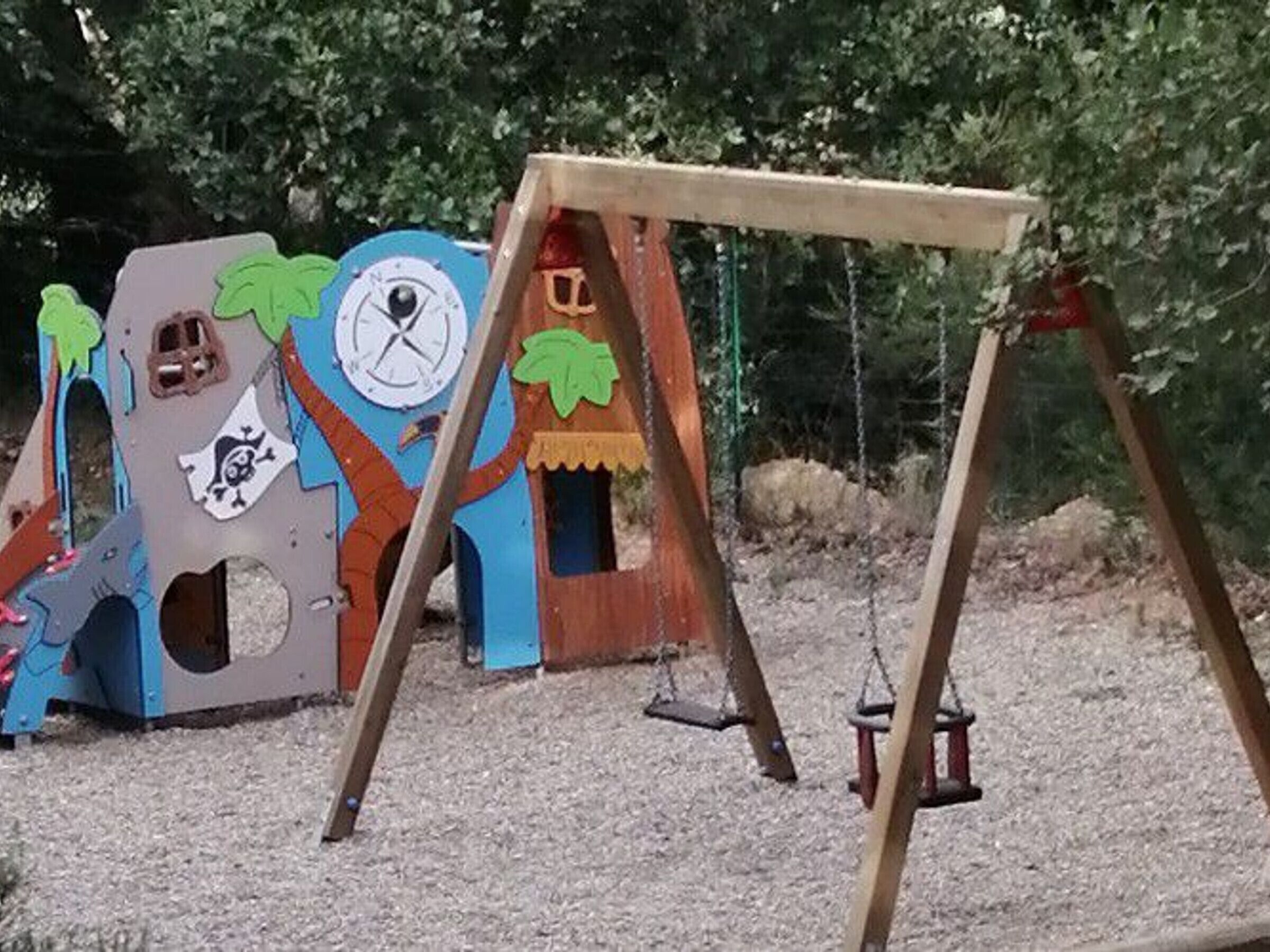 A playground with a slide and swings.