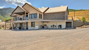 A two-story house with a covered patio, a garage, and a driveway.