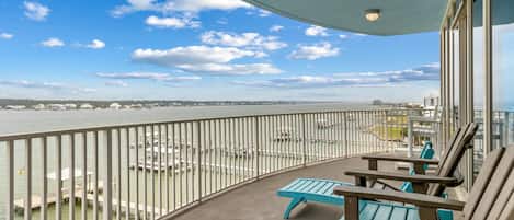 A balcony with a view of a marina and a body of water.