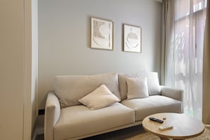 Studio, 1 Queen Bed with Sofa bed | Living area | Flat-screen TV