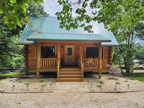 A wooden cabin with a porch, a front door, and a metal roof. - Cedar Cross Cabins 2 bed 2 bath log home. NEW build in Historic French Lick, IN (French Lick)