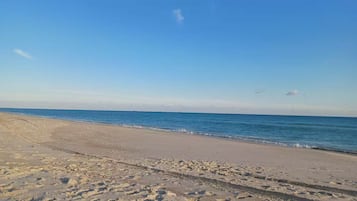 A beach with a clear sky and calm sea.