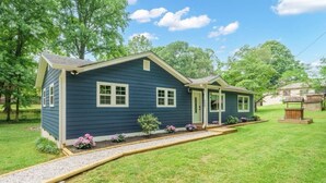 A single-story house with a front porch, a small front yard with a gravel path, and a mailbox. - Holly Acres Retreat (Mount Holly)