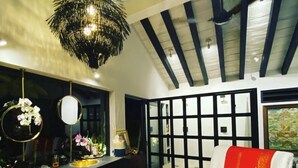 A modern kitchen with a black countertop, gold sink, and a decorative chandelier. - Artist Cliffside Home with private beach access and cabana and two cats. (Punta de mita Bahía de banderas)