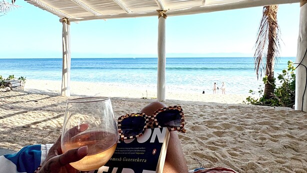 A beach view with a covered area, a book, and a glass of drink. - Artist Cliffside Home with private beach access and cabana and two cats. (Punta de mita Bahía de banderas)