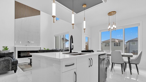 A modern kitchen with a central island, white cabinetry, and pendant lighting. - 4 Bedrooms, 3 washrooms, and 2 living rooms, Luxury Home Close to Amenities (Leduc)