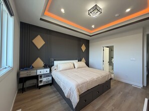 A modern bedroom with a bed, bedside tables, and a desk. - 4 Bedrooms, 3 washrooms, and 2 living rooms, Luxury Home Close to Amenities (Leduc)