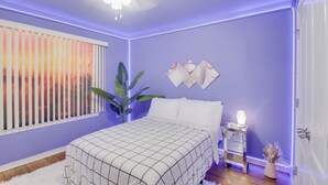 A bedroom with a bed, a nightstand, a plant, and a window with blinds. - 3 Mi to Escambia Bay: Home w/ Deck & Private Yard! (Milton)