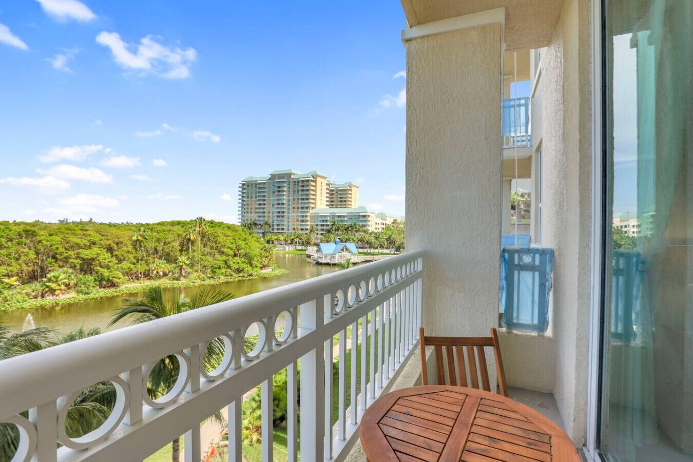 A balcony with a view of a river and buildings in the distance.