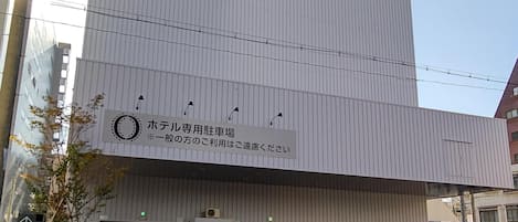 A modern building with a large sign indicating a hotel dedicated to business travelers.